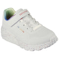 A white sneaker sits upright featuring a padded tongue and laces alongside a Velcro strap with the brand name Skechers on it set against a light background.
