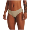 A pair of beige underwear is displayed prominently highlighting its smooth texture and design the surrounding context features a model's hand resting against her thigh with a visible tattoo on her arm.