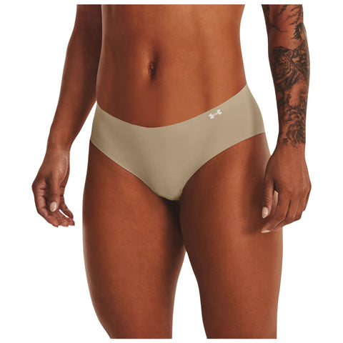 A pair of beige underwear is displayed prominently highlighting its smooth texture and design the surrounding context features a model's hand resting against her thigh with a visible tattoo on her arm.