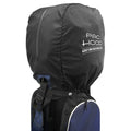 A black golf bag rain cover is placed over a golf bag with straps and storage pockets visible underneath the cover indicating its use in wet weather conditions.