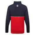 A long-sleeved pullover has a navy blue upper section and a vibrant red lower section featuring contrasting stitching and a high collar with a logo at the back.