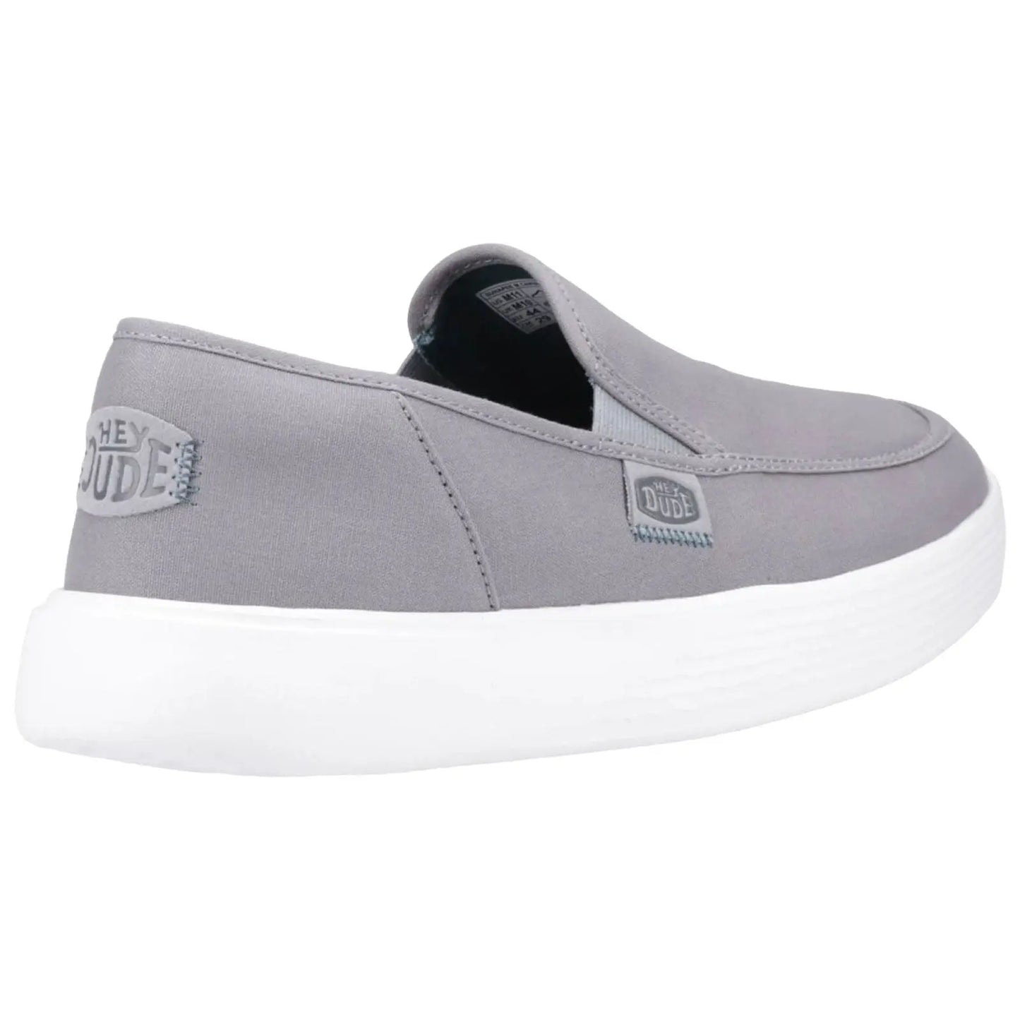 A grey slip-on shoe features a white sole and elastic side panels designed for easy wear with a brand label on the side emphasizing a casual style suitable for relaxed environments.