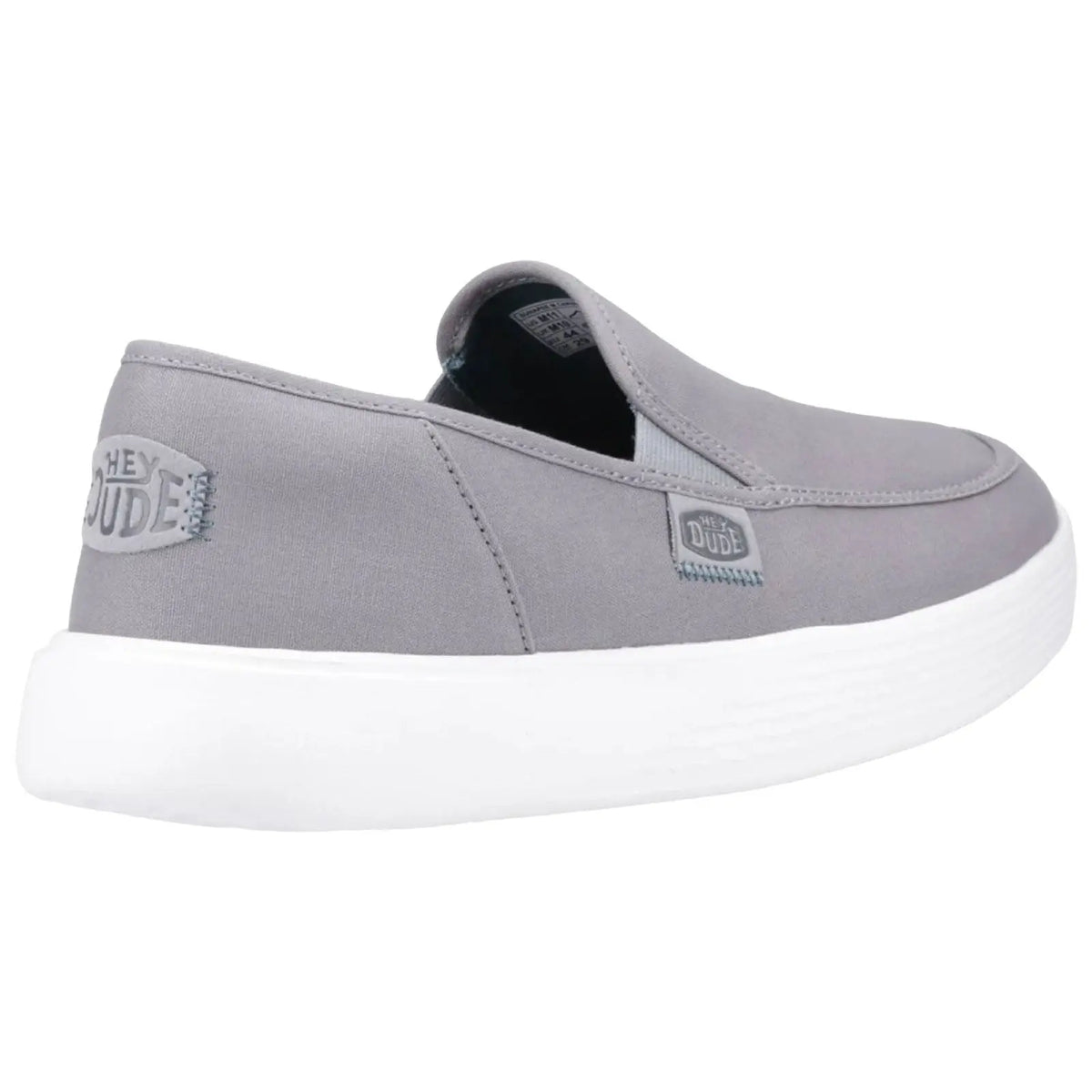 A grey slip-on shoe features a white sole and elastic side panels designed for easy wear with a brand label on the side emphasizing a casual style suitable for relaxed environments.