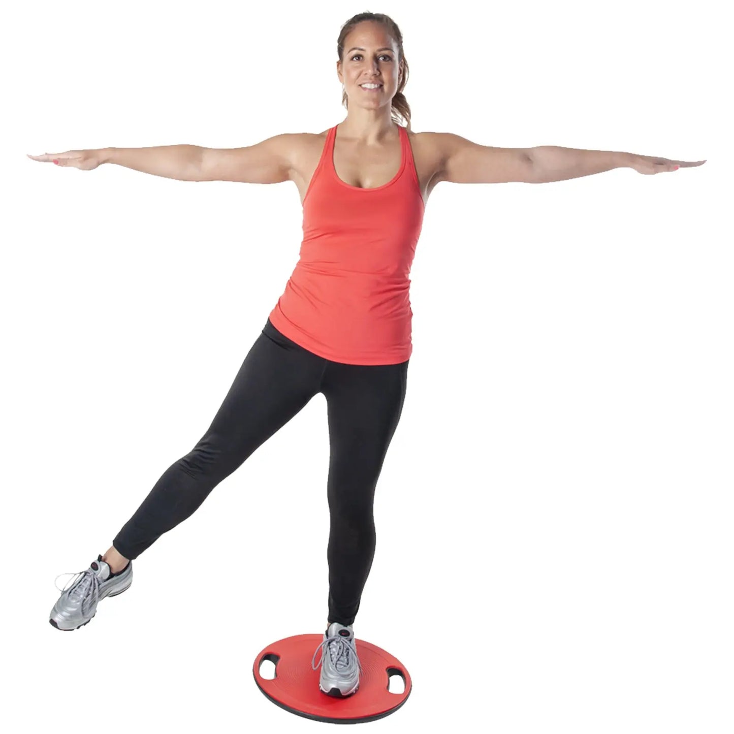 A woman in a red tank top and black leggings stands on a balance board with one leg raised and arms extended for balance in a neutral background.