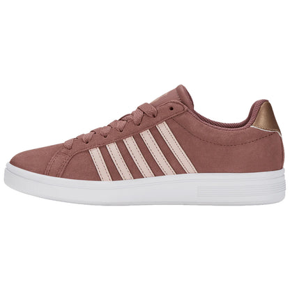 A pink sneaker with white stripes is positioned sideways showcasing its laces and rounded toe against a plain white background highlighting its casual design and clean lines.