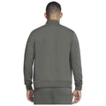 A person wearing a green sweatshirt is standing with their back facing the viewer, in a plain background that emphasizes the clothing without any additional context or details.