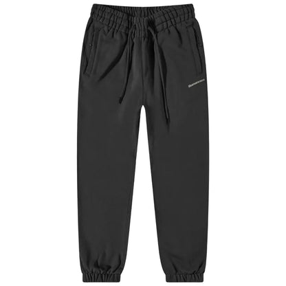 Black sweatpants are displayed flat with an elastic waistband and drawstring featuring side pockets and tapered cuffs designed for comfort and casual wear in relaxed settings