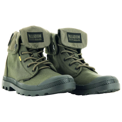 Green canvas boots with sturdy rubber soles are positioned side by side laced up and featuring a foldable top flap labeled Palladium showcasing a casual outdoor style suitable for various terrains