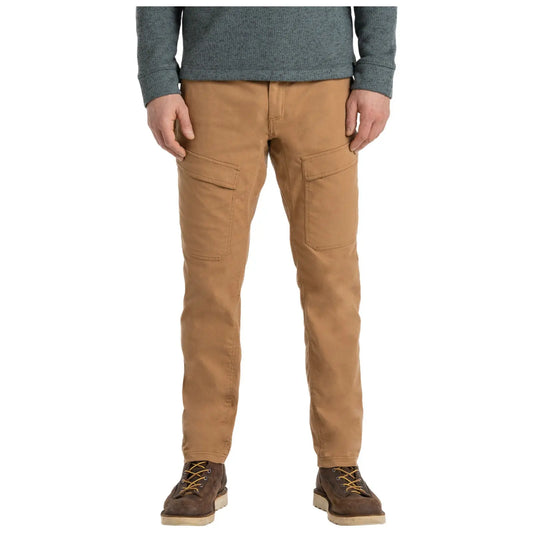 Brown pants with cargo pockets are worn by a person standing upright while wearing a gray long-sleeve shirt and brown boots in a neutral background setting.