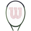 A tennis racket with a green frame features a red "Wilson" logo in the strings, positioned against a white background, emphasizing its brand identity and design.