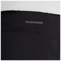 A black garment features a small pocket with the text CRAGHOPPERS embroidered above it, suggesting an outdoor or adventure context. The fabric appears smooth and durable.
