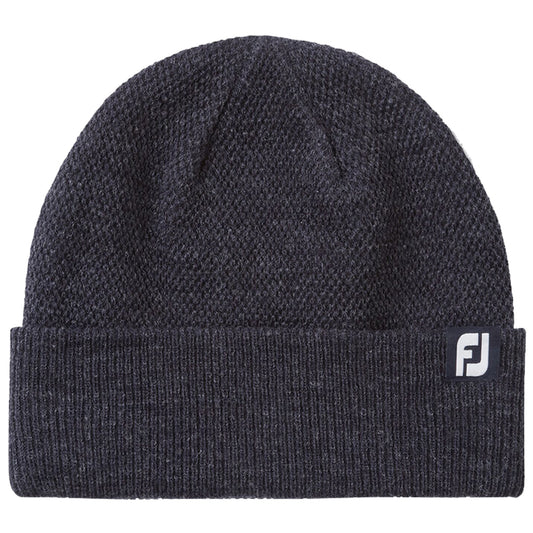 A dark gray knit beanie sits flat showing its textured fabric and folded cuff featuring a small logo tag indicating the brand. The setting is neutral and unobtrusive.