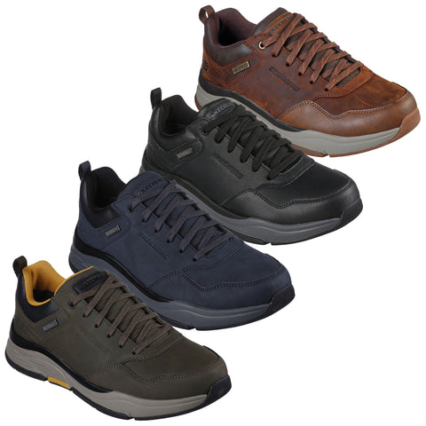 Four pairs of athletic shoes are displayed in varying colors including brown black dark navy and olive green arranged in a row against a white background showcasing their design and color diversity.