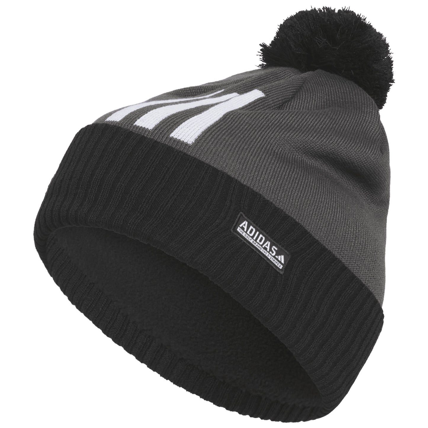 A gray knitted beanie with a black underside and a pom-pom on top features white text and an Adidas logo tag on the side. It is designed for warmth and style.