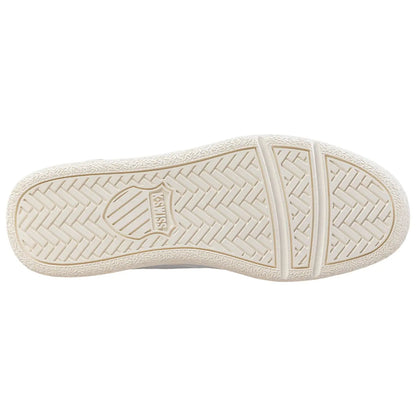 A sneaker sole is displayed prominently showing a textured rubber pattern with a logo in the center indicating brand name the background is plain and unobtrusive.