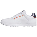 A white athletic shoe is displayed with a smooth leather surface lace-up design and decorative perforations featuring a subtle orange stripe and a black heel tab on a plain background.