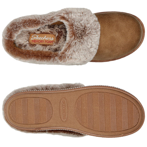 A brown fur-lined slipper rests on a flat surface showcasing its textured sole and memory foam interior with a label indicating it is from Skechers.
