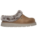 A brown slip-on shoe features a fur-lined collar and a thick, textured outsole. It sits on a white background, emphasizing its soft material and casual style.
