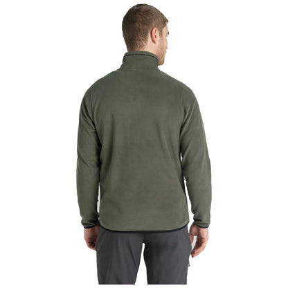 A person is wearing a green fleece jacket with a high collar and facing away from the viewer in a neutral background. The attire appears casual and suitable for outdoor activities.