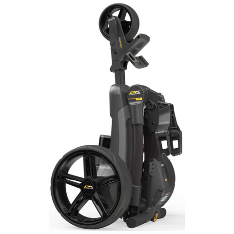 A compact golf push cart stands upright showcasing its black wheels and gray body. It is designed for easy transport and storage, illustrating innovative engineering for a golfing experience.
