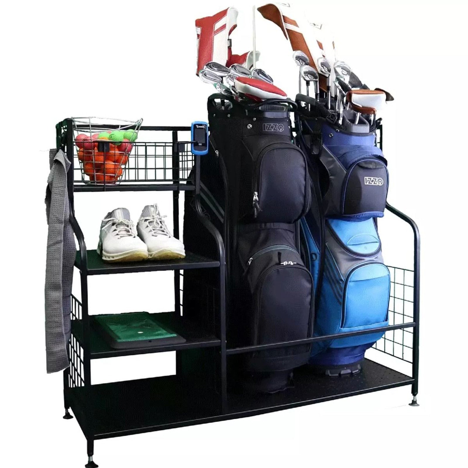 A black metal golf rack holds two golf bags with clubs while displaying white golf shoes on a shelf alongside a basket of colored practice balls and a green mat.