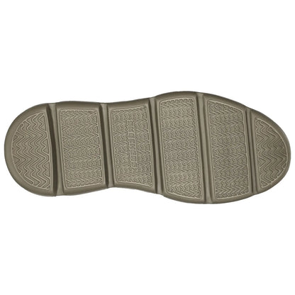 A shoe sole displays a textured grip pattern designed for traction while resting on a flat surface with no visible context or additional elements in the background.