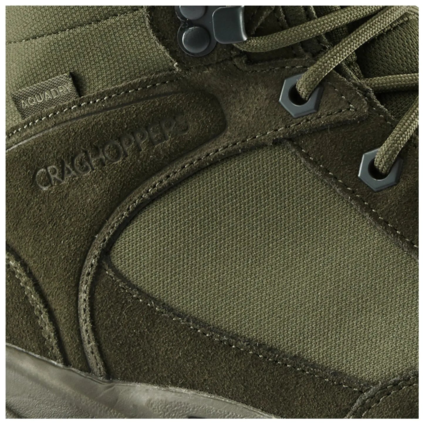 A green hiking boot features textured suede and fabric materials with a reinforced toe and secure lacing system showing brand name Craghoppers and tag labeled Aquadry