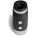A small handheld binocular features a black textured surface with silver accents and two buttons on the side designed for adjusting focus in various outdoor settings