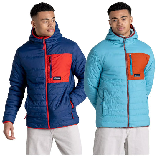A young man is wearing two different colorful jackets side by side the left jacket is dark blue with a red patch the right jacket is light blue with an orange patch