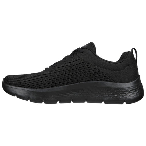 A black athletic shoe is displayed sideways showcasing its mesh and fabric material with a cushioned sole indicating a design for comfort and activity in urban or casual settings.