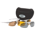 Sunglasses with interchangeable lenses are positioned beside a protective carrying case. The brown-tinted lenses are attached to the frame, with additional yellow and gray lenses nearby for different lighting conditions.