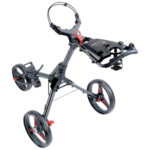 A golf push cart with three wheels stands upright featuring a handle and storage space for golf accessories in a sleek black and red design.