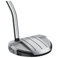 A golf putter features a sleek silver head with ridges for grip positioned at an angle above a black base showcasing a smooth metallic shaft in a neutral background
