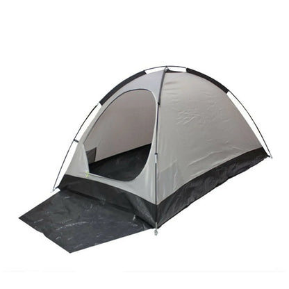 A gray and black tent stands upright with an open entrance revealing the interior floor while a black tarp extends from its base providing additional ground coverage in an undefined space.