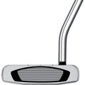 A golf putter rests horizontally with a shiny metallic surface and a textured black striking area; it's designed for smooth, precise shots on a golf course green.