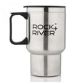 A stainless steel travel mug with a black handle features the text ROCK+RIVER prominently displayed on the side and includes a black lid on top for covering beverages.