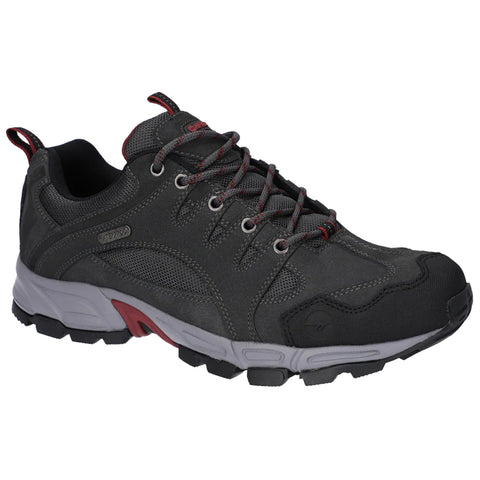Two pairs of athletic shoes are stacked side by side showcasing a brown and a gray design both featuring laces and textured surfaces suitable for outdoor activities and labeled waterproof