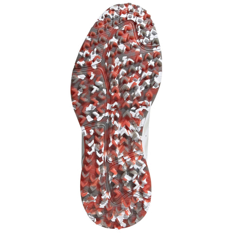 A athletic shoe sole showcases a textured pattern with red and white elements designed for traction on various surfaces in a sports or outdoor environment.