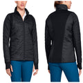 A black jacket with a quilted front and solid back is worn by a woman who is standing and slightly turning. The environment appears casual and suitable for activewear.