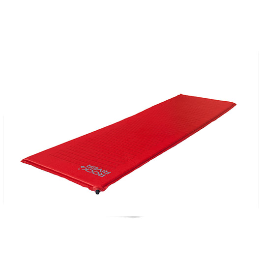 A long red sleeping pad lies flat on a white surface designed for outdoor camping providing insulation and comfort for resting in various environments.