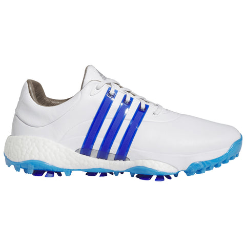 A white athletic shoe features three blue stripes on the side and a textured outsole colored in blue with spikes for traction designed for sports or outdoor activities.