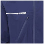 A navy blue jacket features a white logo on the chest with a zippered pocket visible on the front side, placed in a neutral indoor setting.
