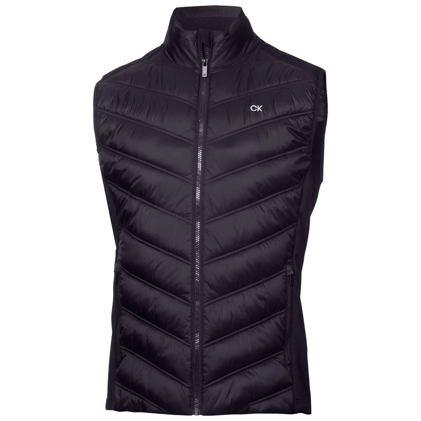 A black puffy vest with a high collar is displayed upright featuring a chevron pattern and a front zipper showcasing a small CK logo on the left chest area.