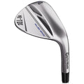 A golf wedge is positioned with its angled face visible showcasing shiny metal and intricate grooves designed for grip and control during a short shot on the golf course.