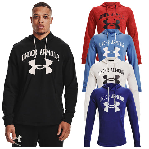 A man wearing a black sweatshirt stands confidently while showcasing several colored hoodies arranged behind him all labeled with the Under Armour logo in bold text