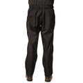Black waterproof pants are worn by a person standing with their back to the viewer in an outdoor setting, suitable for adverse weather conditions, featuring a relaxed fit and elastic waistband.