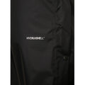 A black jacket features a small logo with the text HYDROSHELL prominently displayed on the fabric with a smooth texture designed for weather protection in outdoor contexts.
