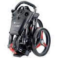 A compact black and red stroller is folded for storage featuring a distinct handle and wheels showcasing a modern sleek design suitable for navigating various environments.