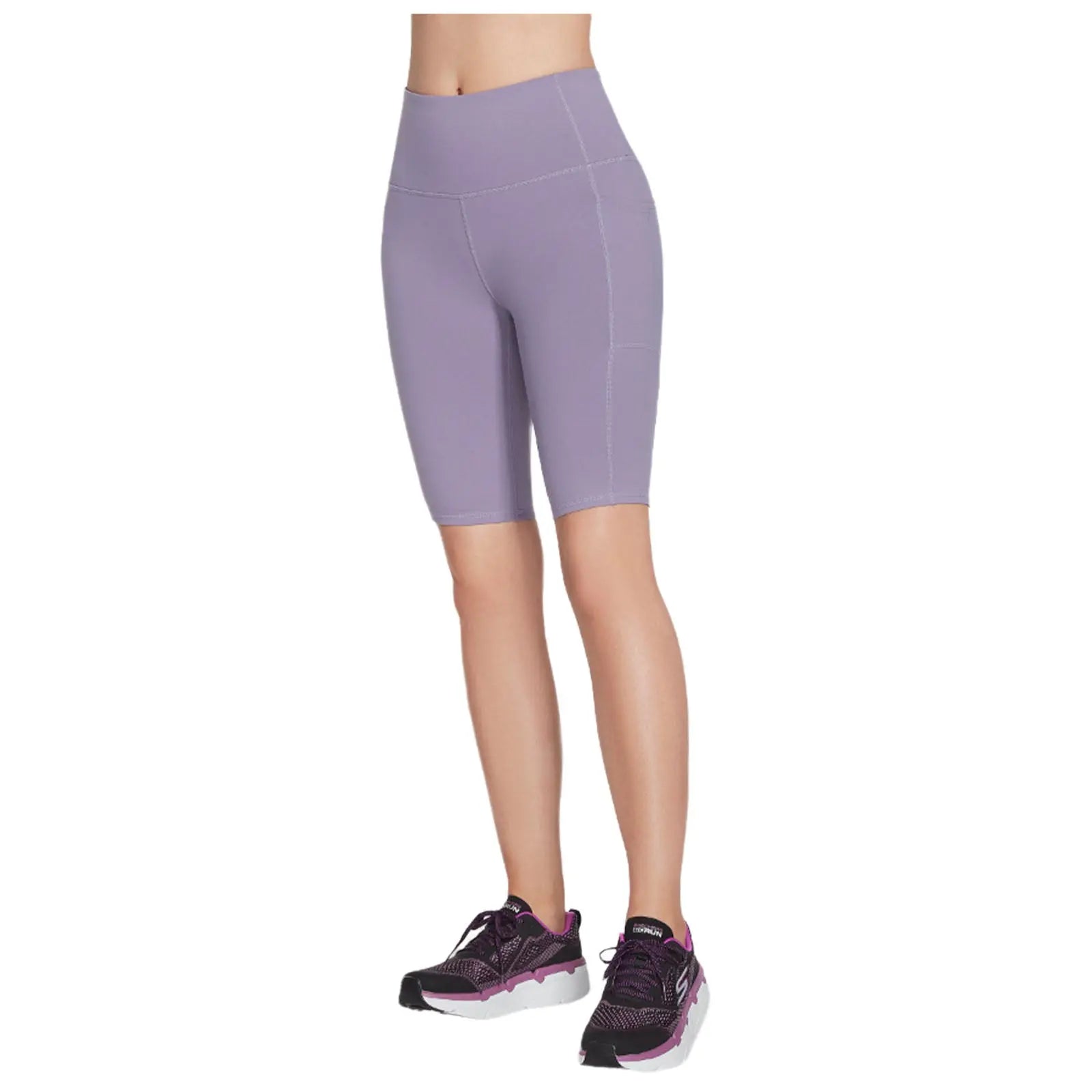 A person is wearing light purple cycling shorts paired with black and purple athletic shoes in a neutral background showcasing activewear suitable for exercise or casual wear.