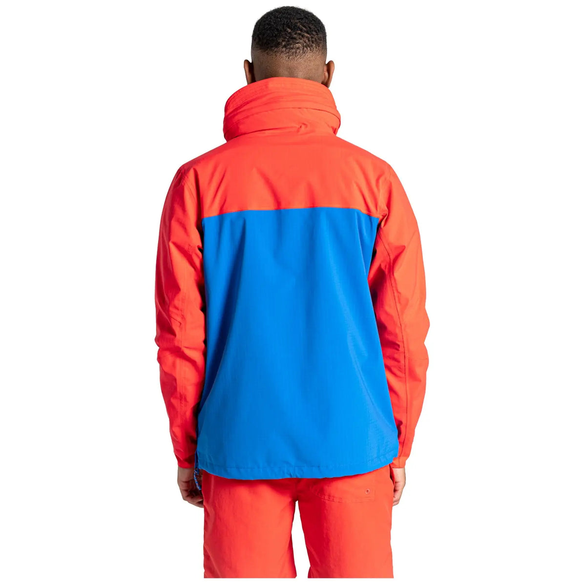 A multi-colored jacket features a bright red hood and upper section with a blue lower section and includes a front pocket designed for outdoor activities in casual settings.
